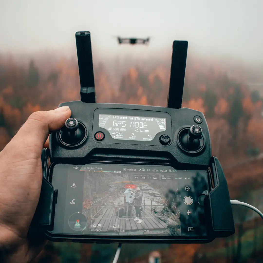Drone controller in hand.