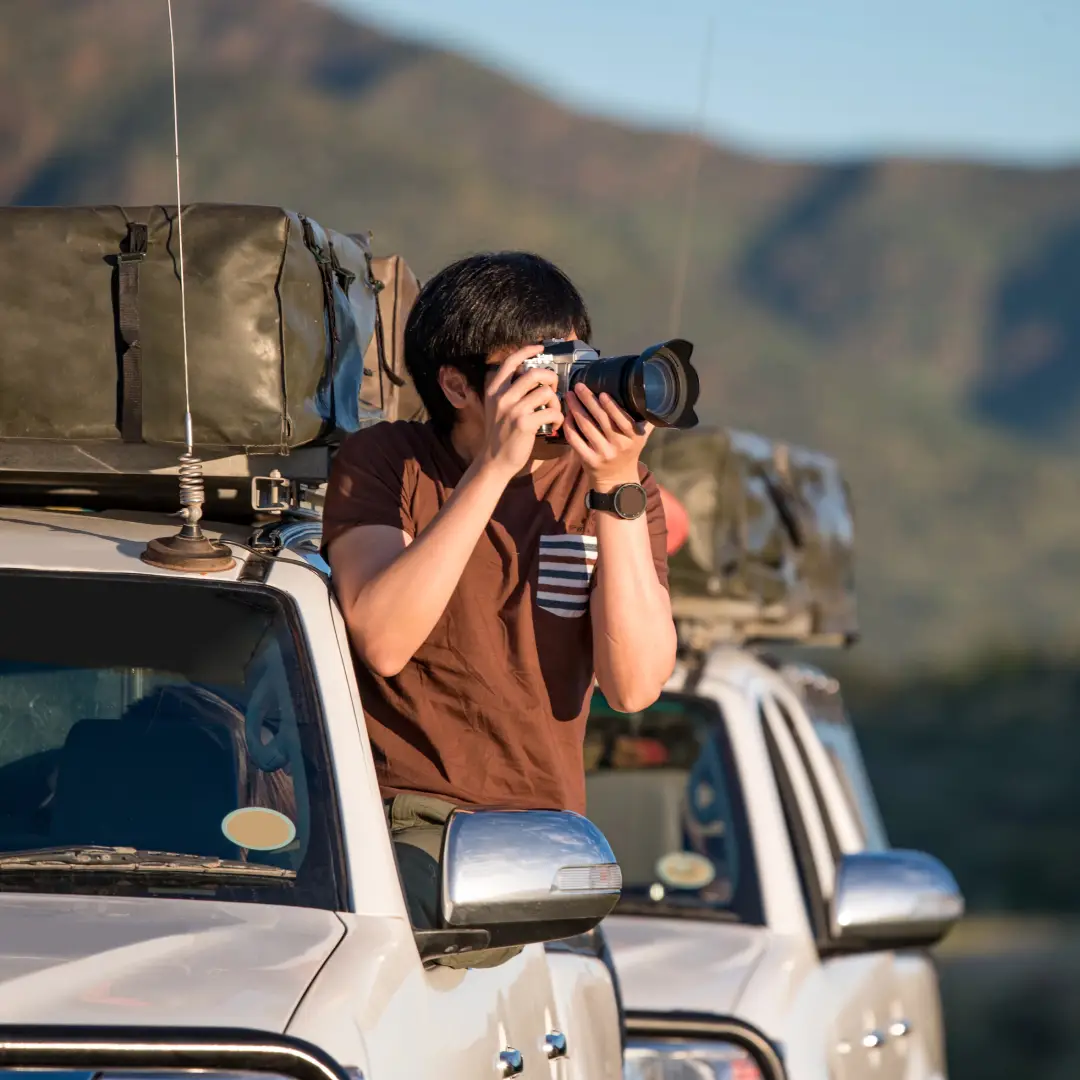 Photographer on a safari vehicle.